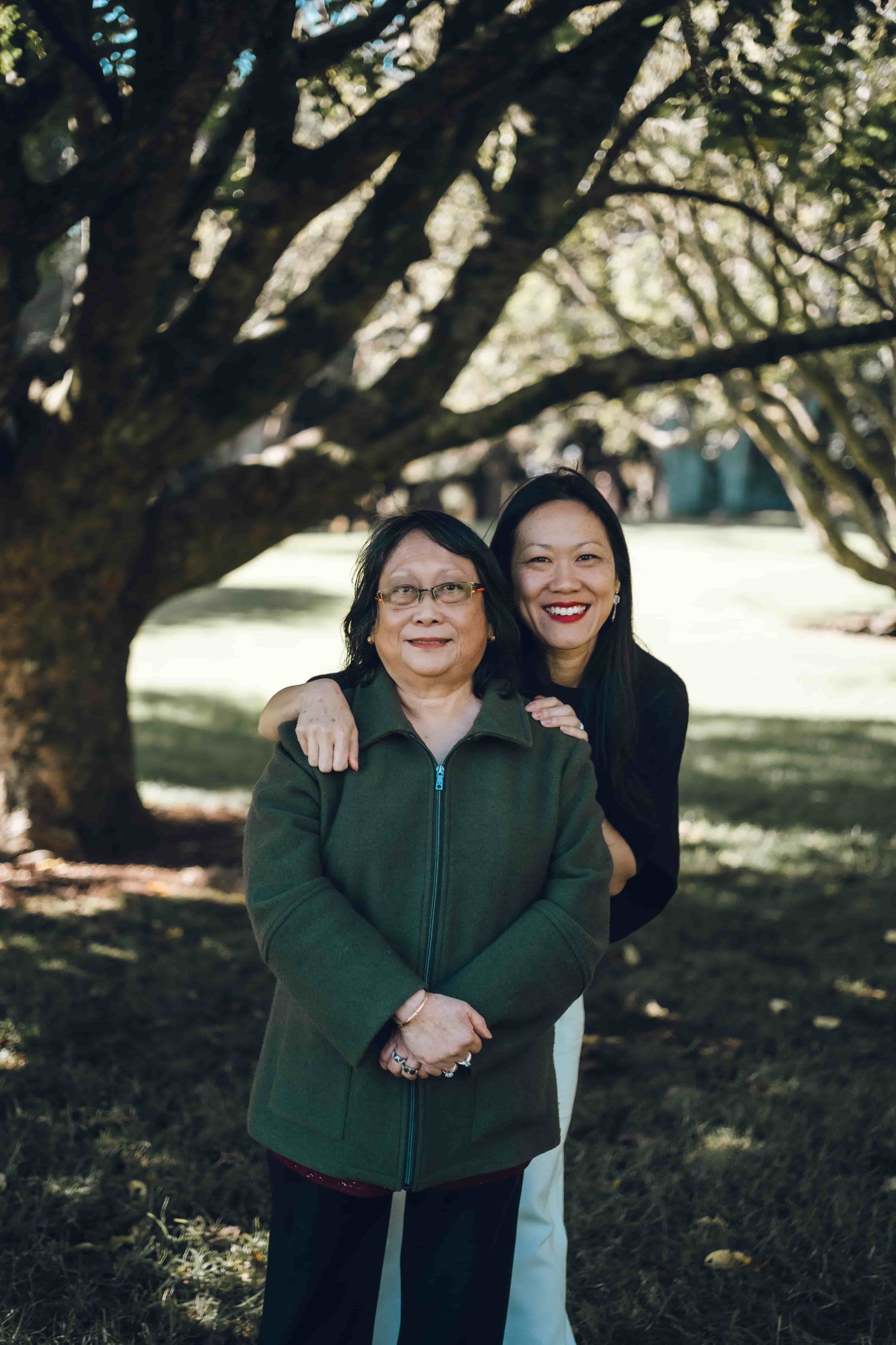 Daughter with her arms around her mother's shoulders
