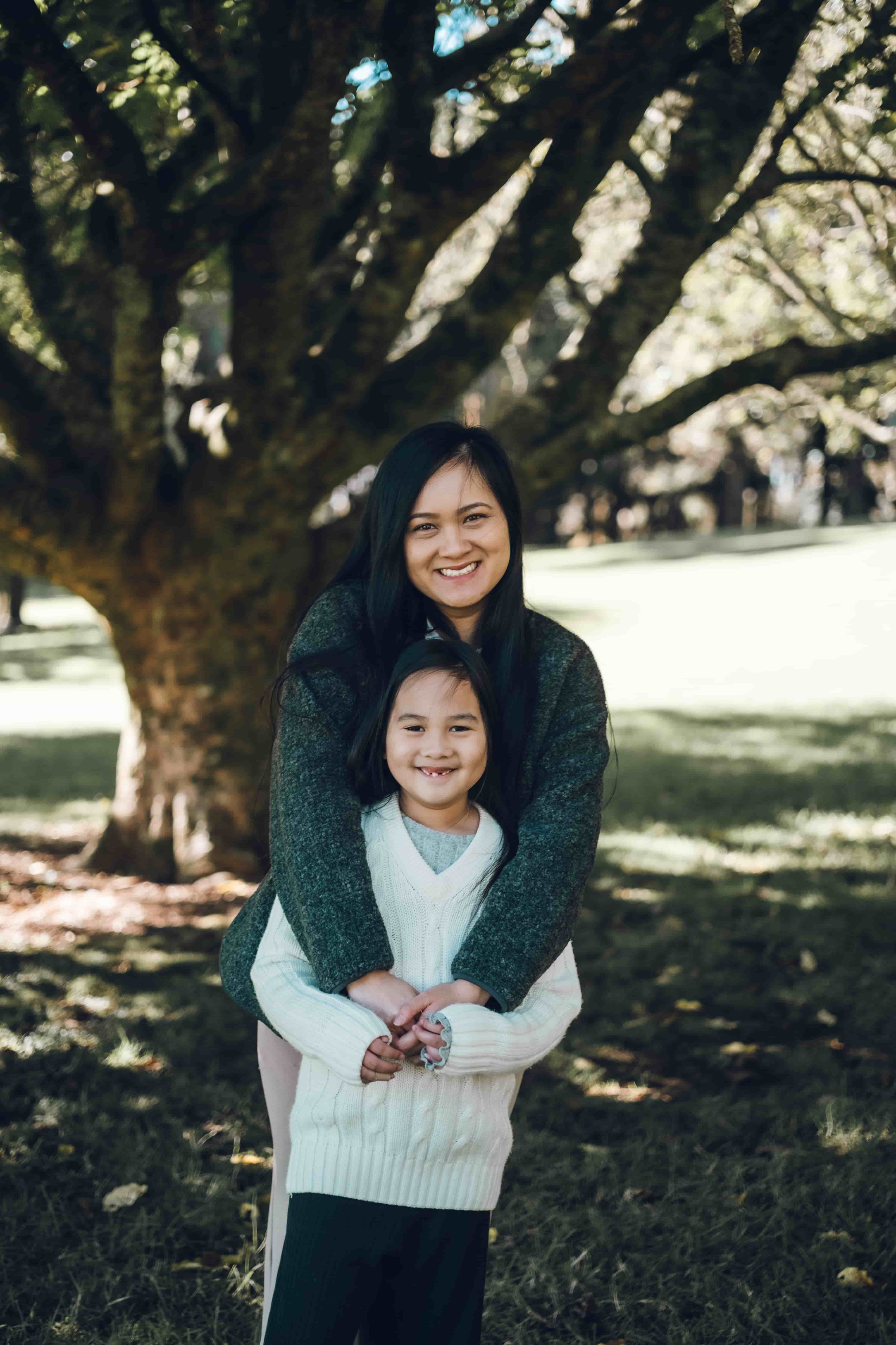 Mother hugging her daughter from behind