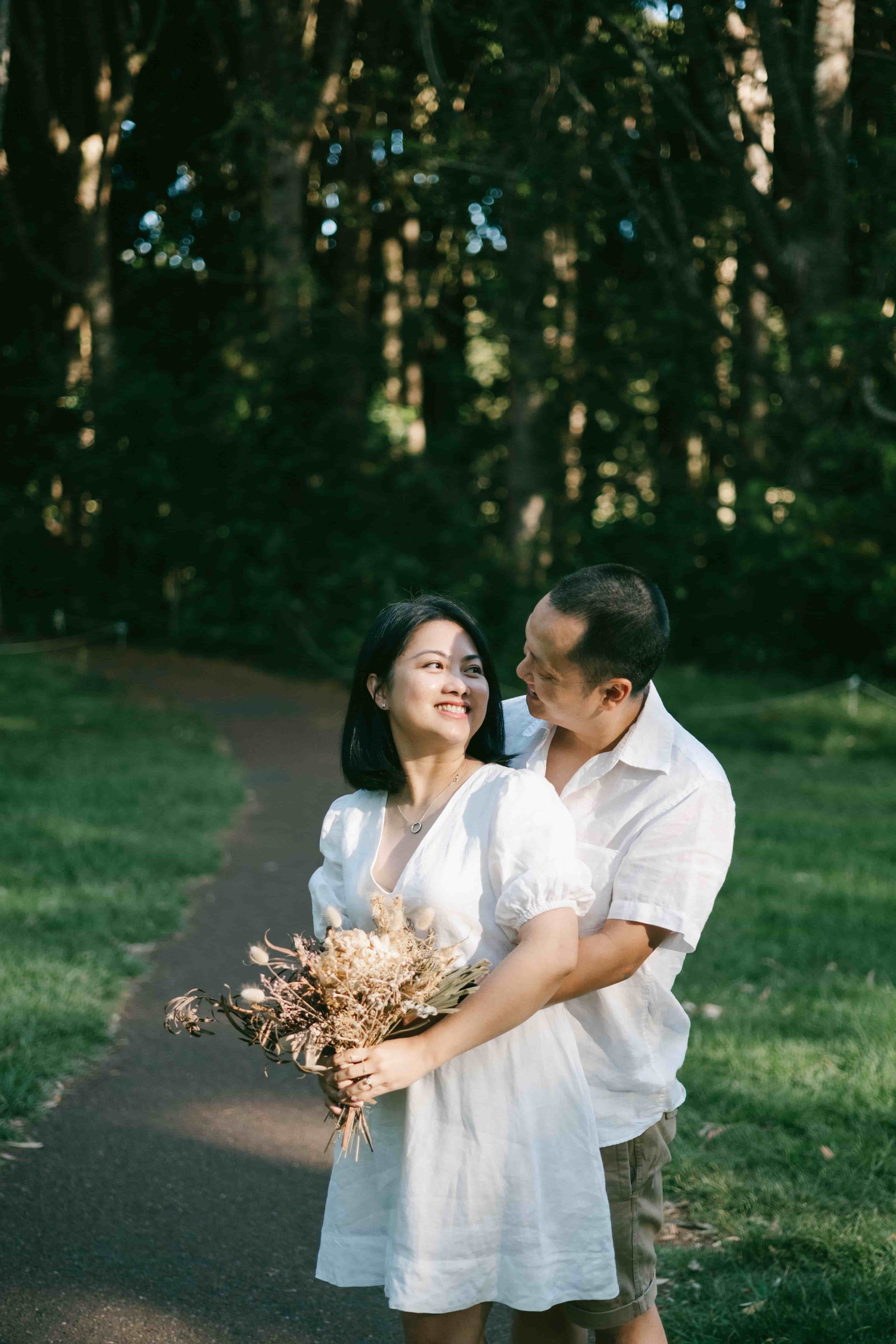 Couple laughing together on a park path