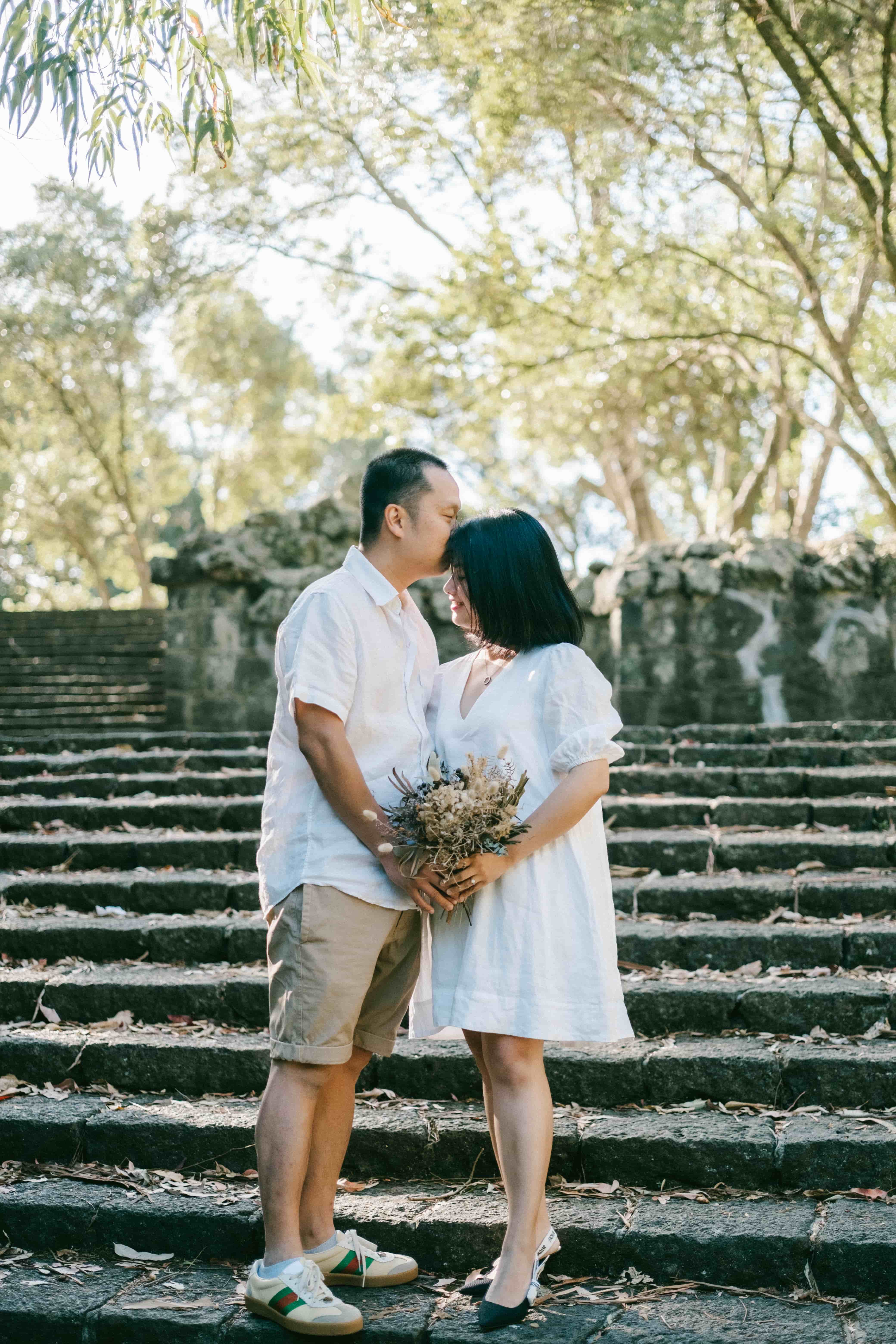 Couple walking hand in hand on stone steps