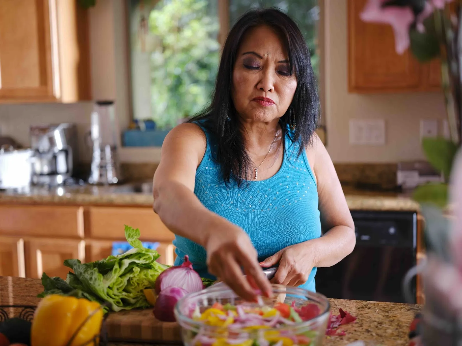 Caregiver preparing fresh vegetables in a kitchen, showing easy meal prep tips and prioritizing nutrition for Caregivers.)