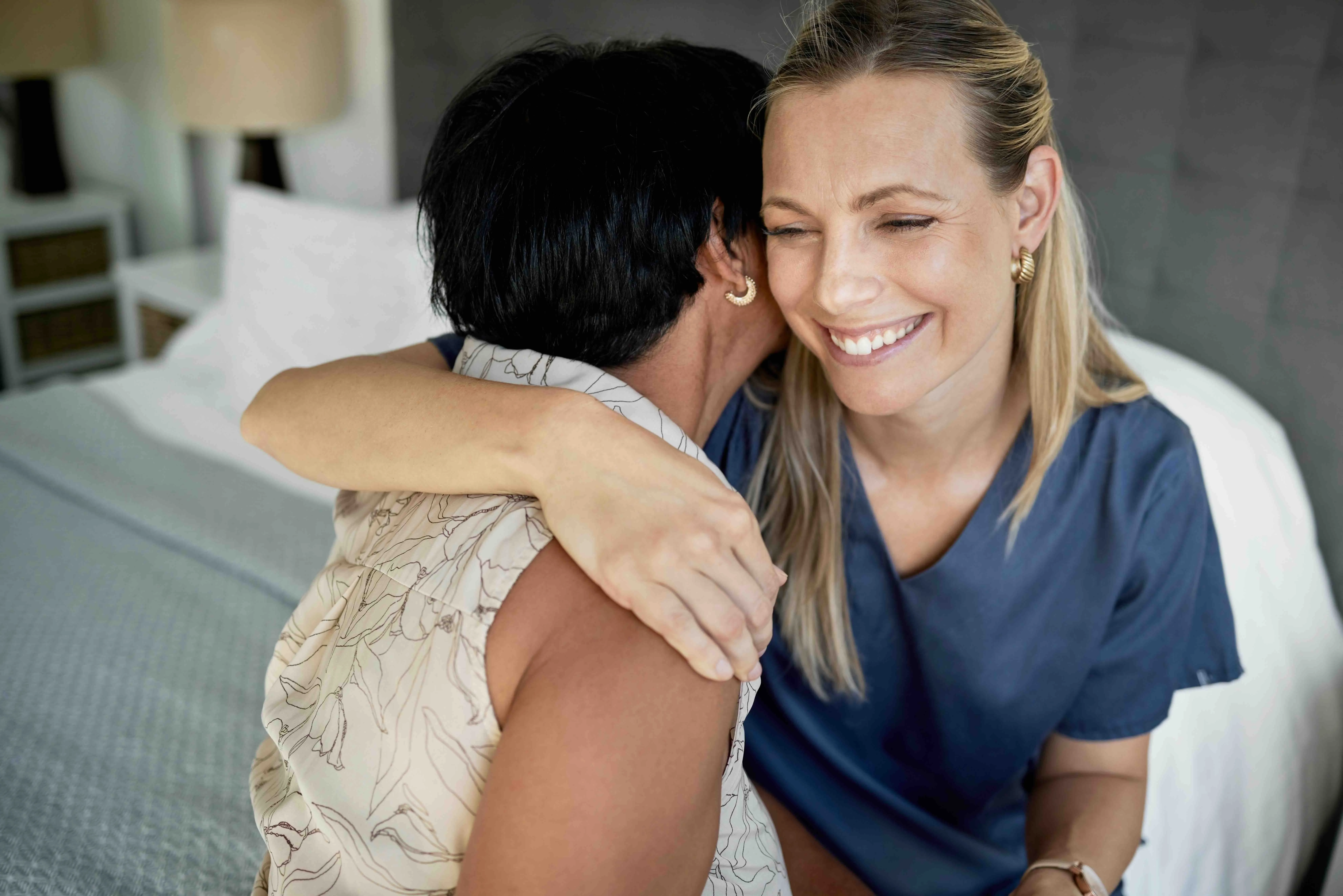 Caregiver sharing a supportive hug with an older adult, highlighting emotional connection and the importance of self-care for caregivers.