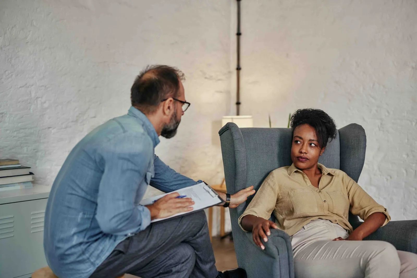 Therapist speaking with a woman during a session, illustrating support for high functioning depression, discussing burnout vs depression, or considering a depression test as part of mental health care.