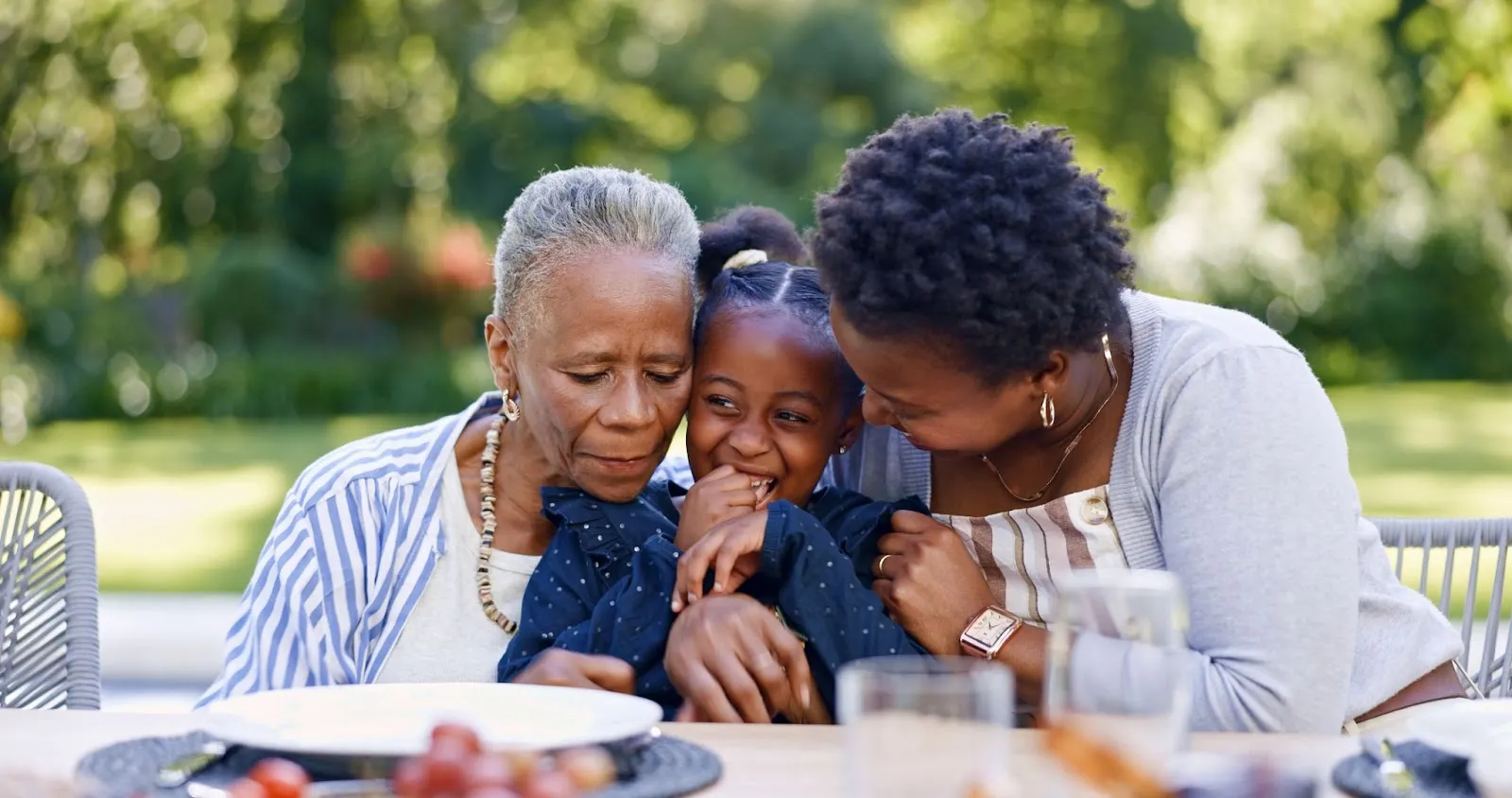 A multigenerational family enjoying time together outdoors, showing the emotional connection supported by home care services. The image highlights the value of at-home care in keeping aging loved ones close, safe, and surrounded by family.