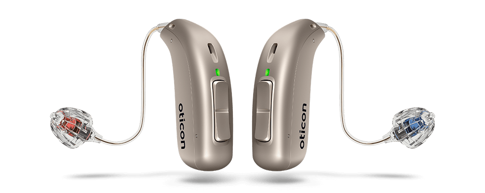 Close-up of Oticon hearing aids in a sleek behind-the-ear design, shown in metallic silver finish