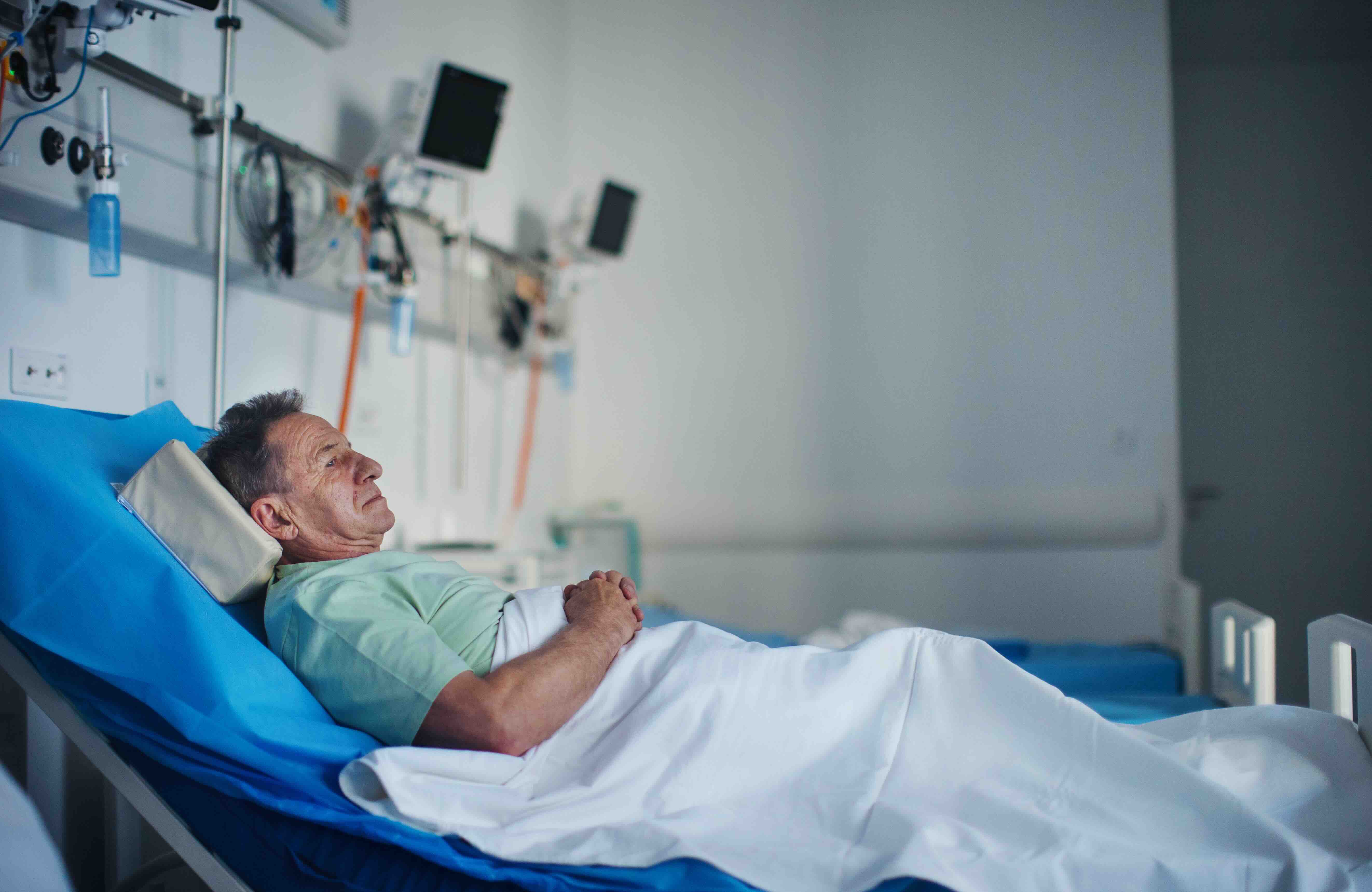 Older adult resting in a hospital bed, illustrating bed sores risk, pressure ulcer prevention, and mobility challenges in a nursing home or nursing facility.