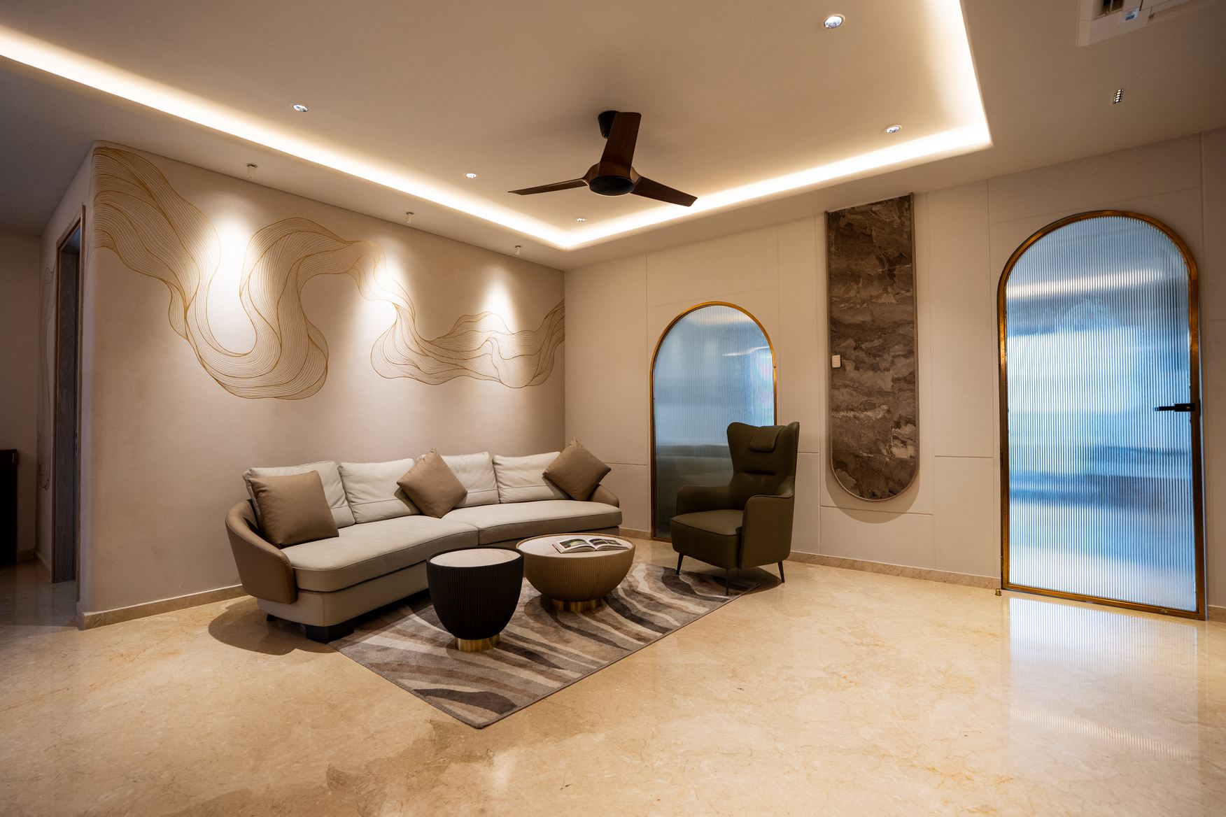 Luxurious residential interior with a cozy sofa and wooden accents, crafted by Elementz.