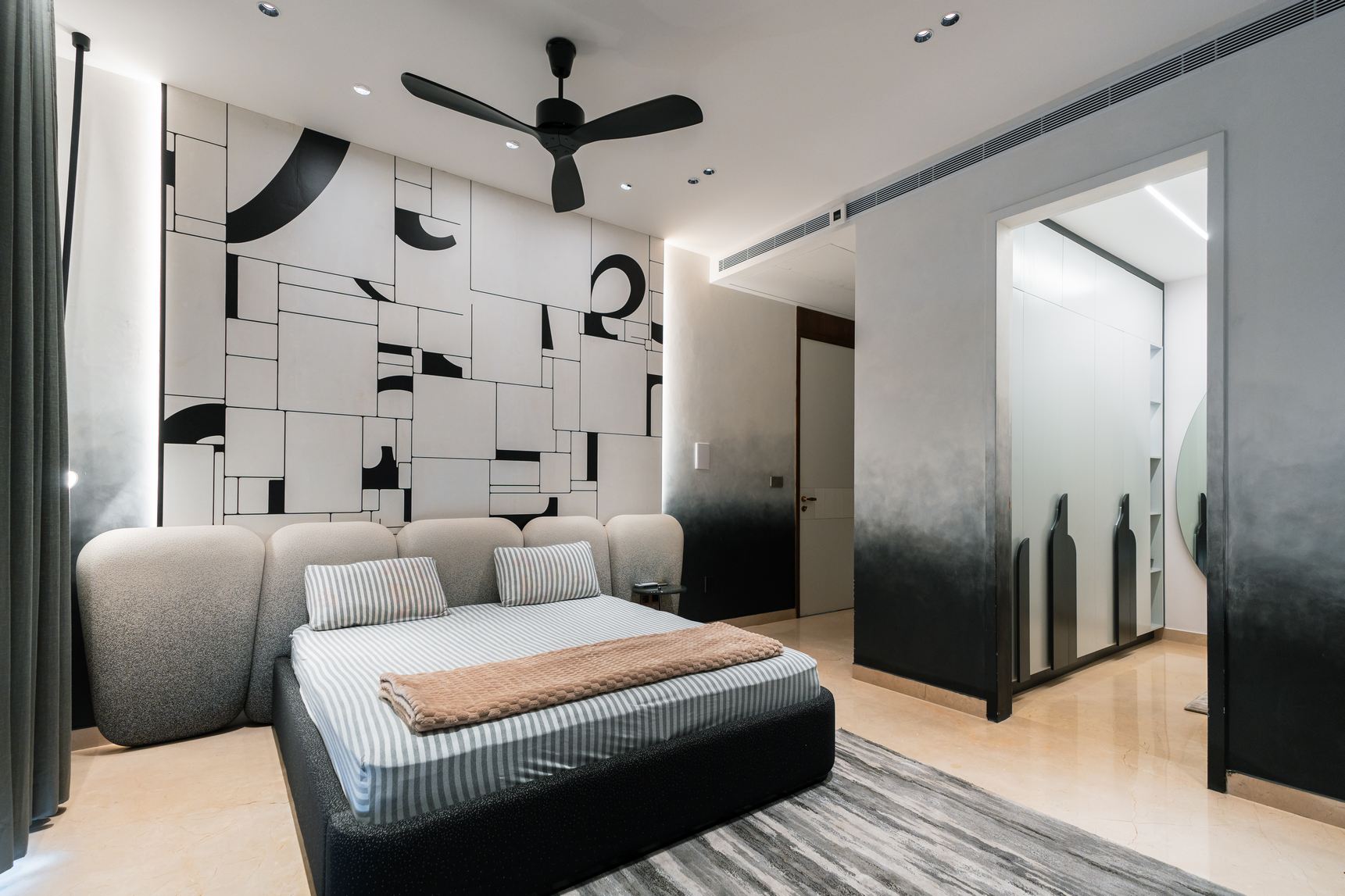 Modern living room with stylish furniture and a monchrome design on th wall, designed by Elementz.