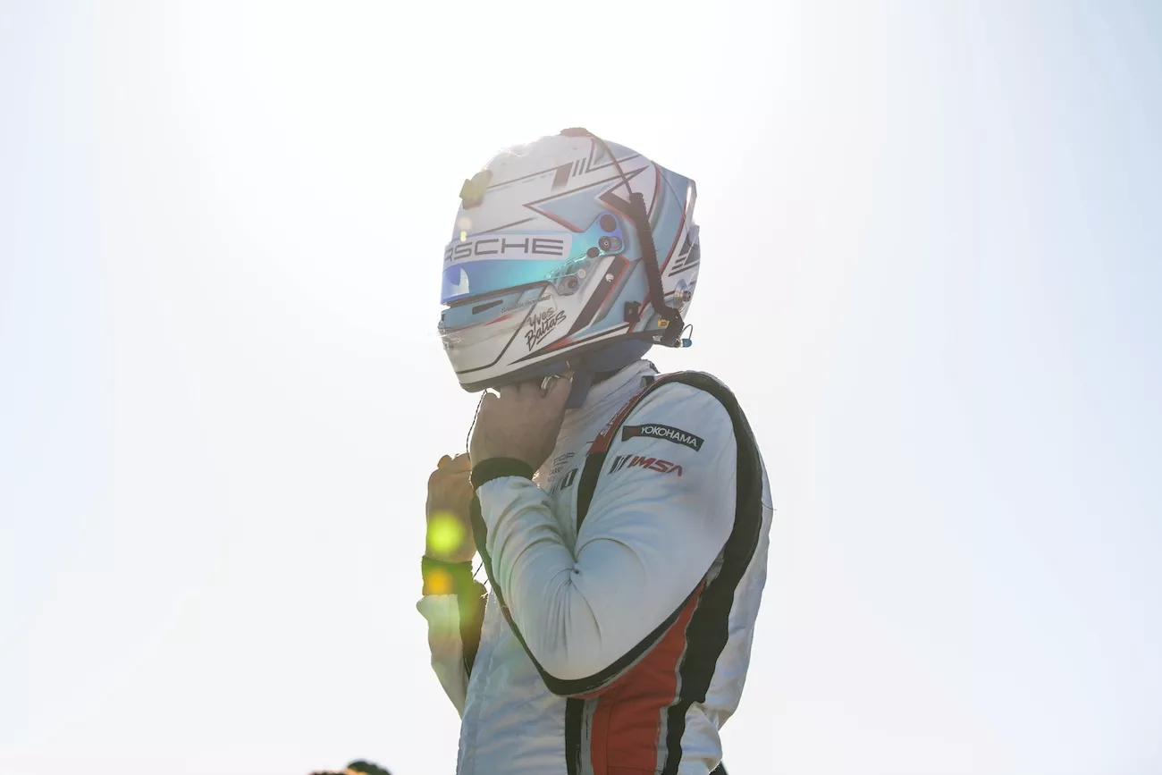 Porsche driver putting on racing helmet trackside at Sebring International Raceway