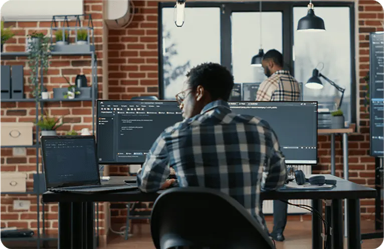 Man sitting on his work desk with laptop having code.