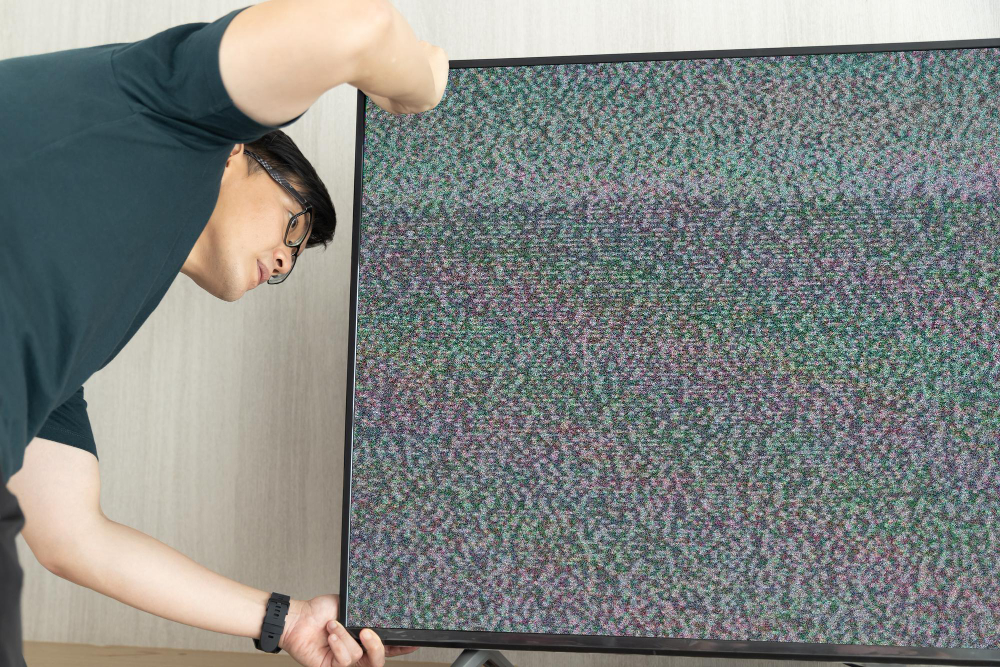 man fixing broken tv