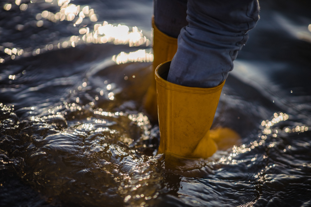close up of person in wellington boots in flood
