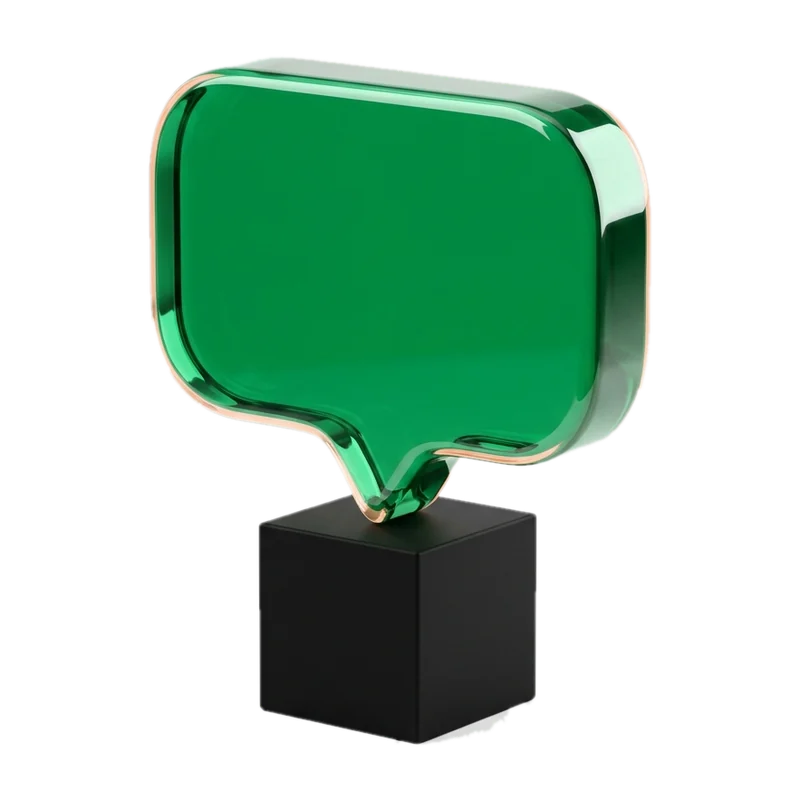 Green glass speech bubble on a black base