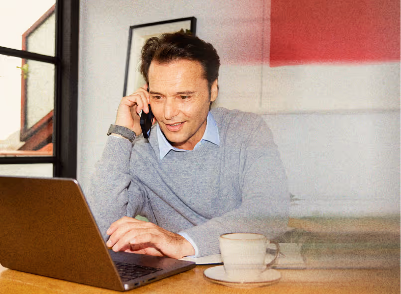 Person on a call while working on laptop, representing recruiters building client trust.