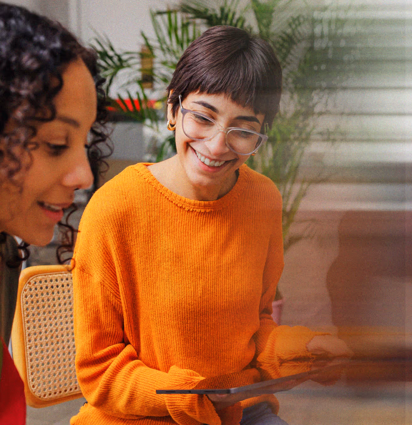 Two people collaborating with tablet, representing talent acquisition teams.