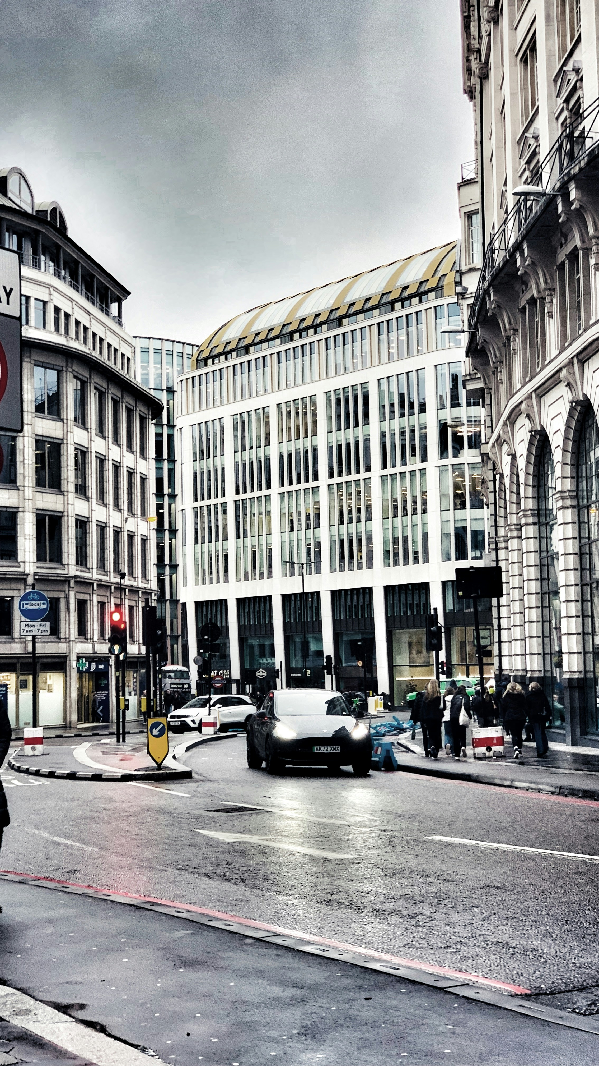 Electric vehicle charging at a public charging point in London with city skyline in background