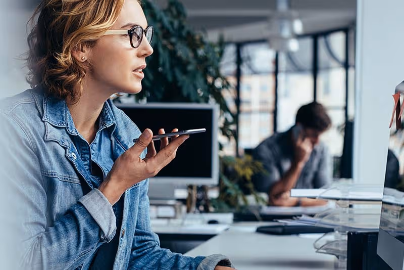 stock photo woman on mobile phone at desk