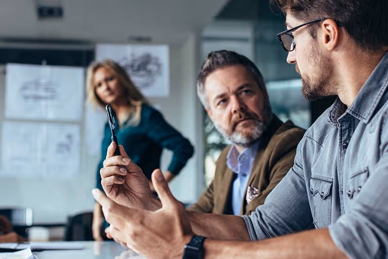stock photo two men and a woman engaged in conversation