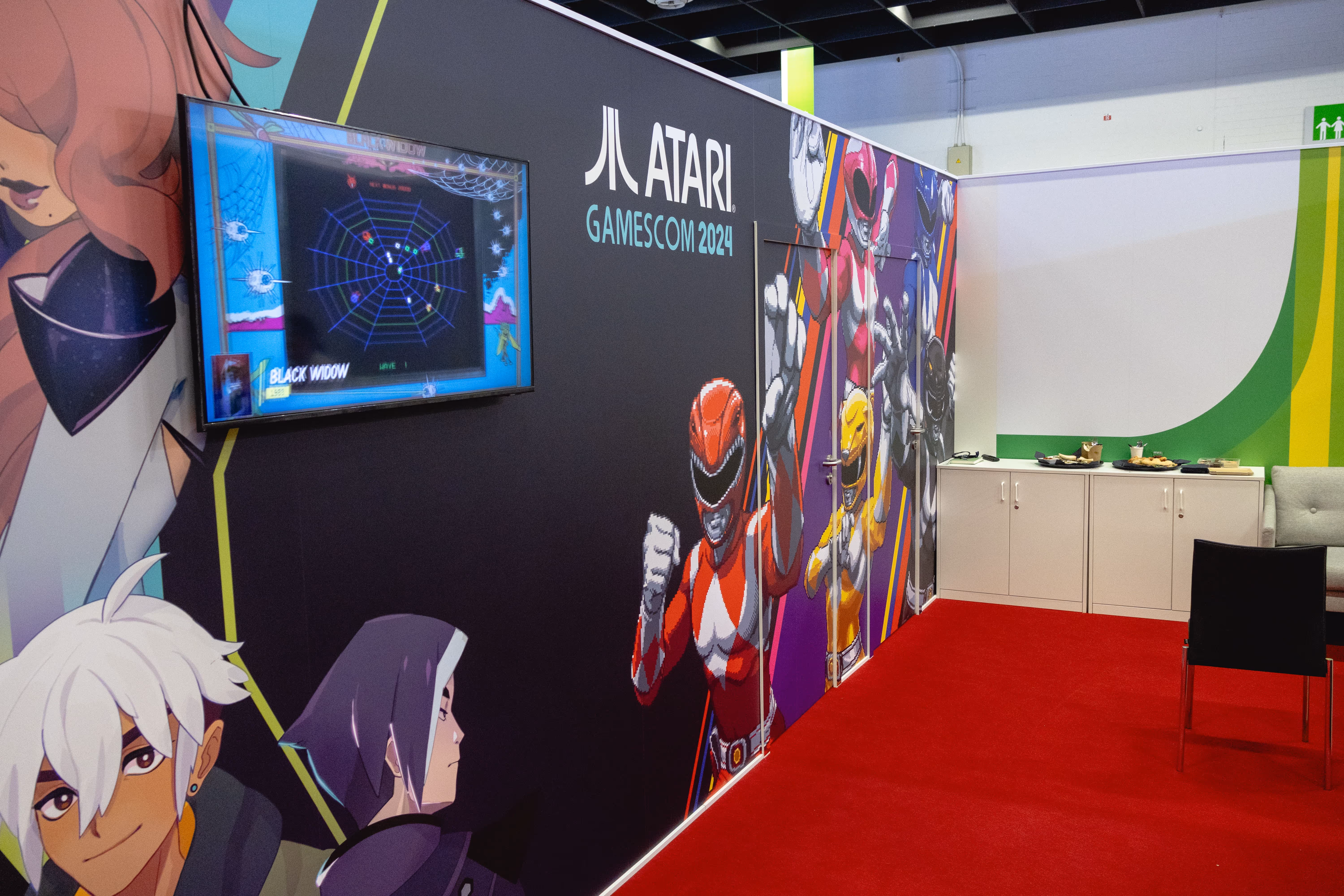 A video game display with a red carpet and a sign that says Atari. -  ÜberStrategist Images