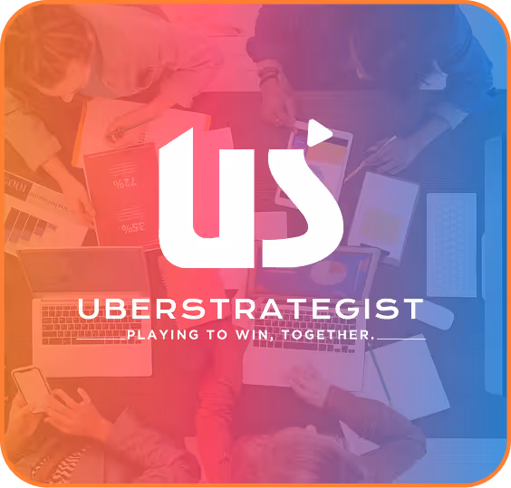 A group of people sitting around a table with laptops and books, with a logo that says "Uberstrategist". - ÜberStrategist Images