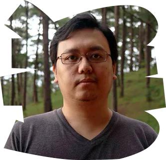 A man wearing glasses and a gray shirt. - ÜberStrategist Images