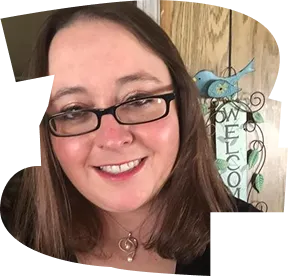 A woman with glasses and a necklace smiling for the camera. - ÜberStrategist Images