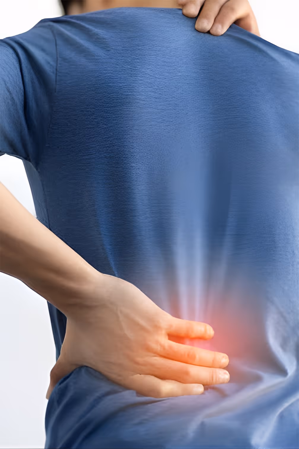 Person holding lower back with hand, red glow indicates pain or discomfort in that area.