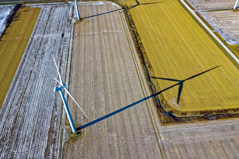 High-angle shot of wind turbines casting shadows on farmland in Dodge Center, MN.