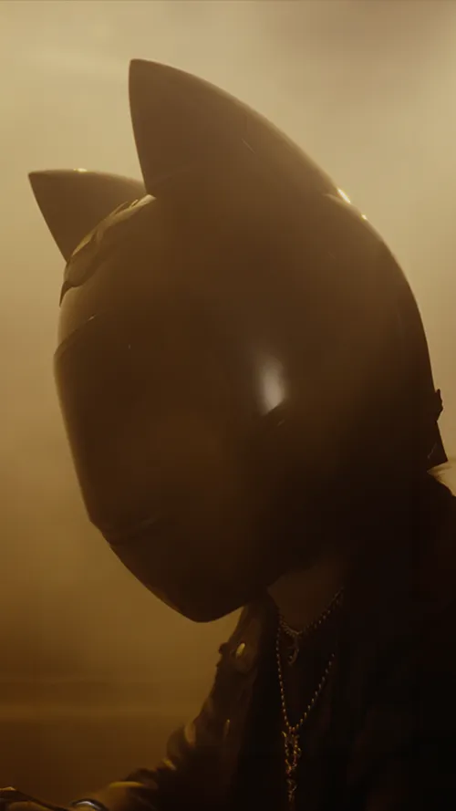 Motorcyclist wearing a helmet with cat ears
