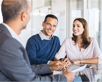 Business professionals smiling during a friendly meeting at office conference table
