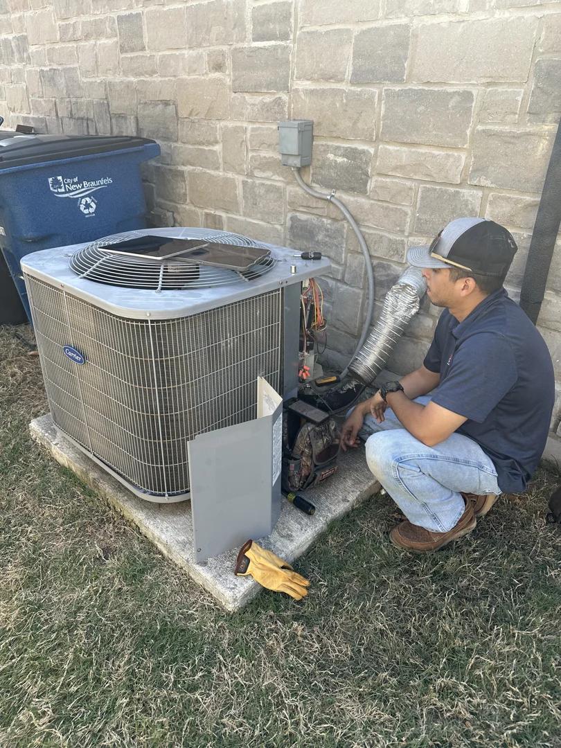 Homeowner safely inspecting an outdoor AC unit for storm debris Homeowner safely inspecting an outdoor AC unit for storm debris