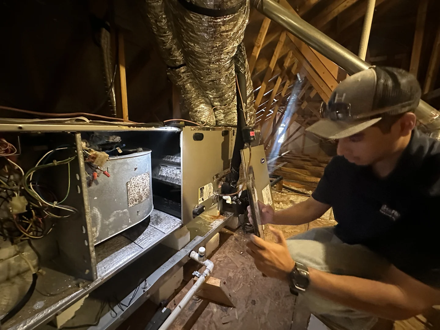 Professional HVAC technician inspecting a newly installed high-efficiency heat pump system Professional HVAC technician inspecting a newly installed high-efficiency heat pump system