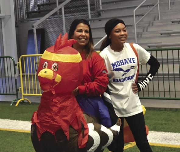 instructor adjusting a dancer's pose