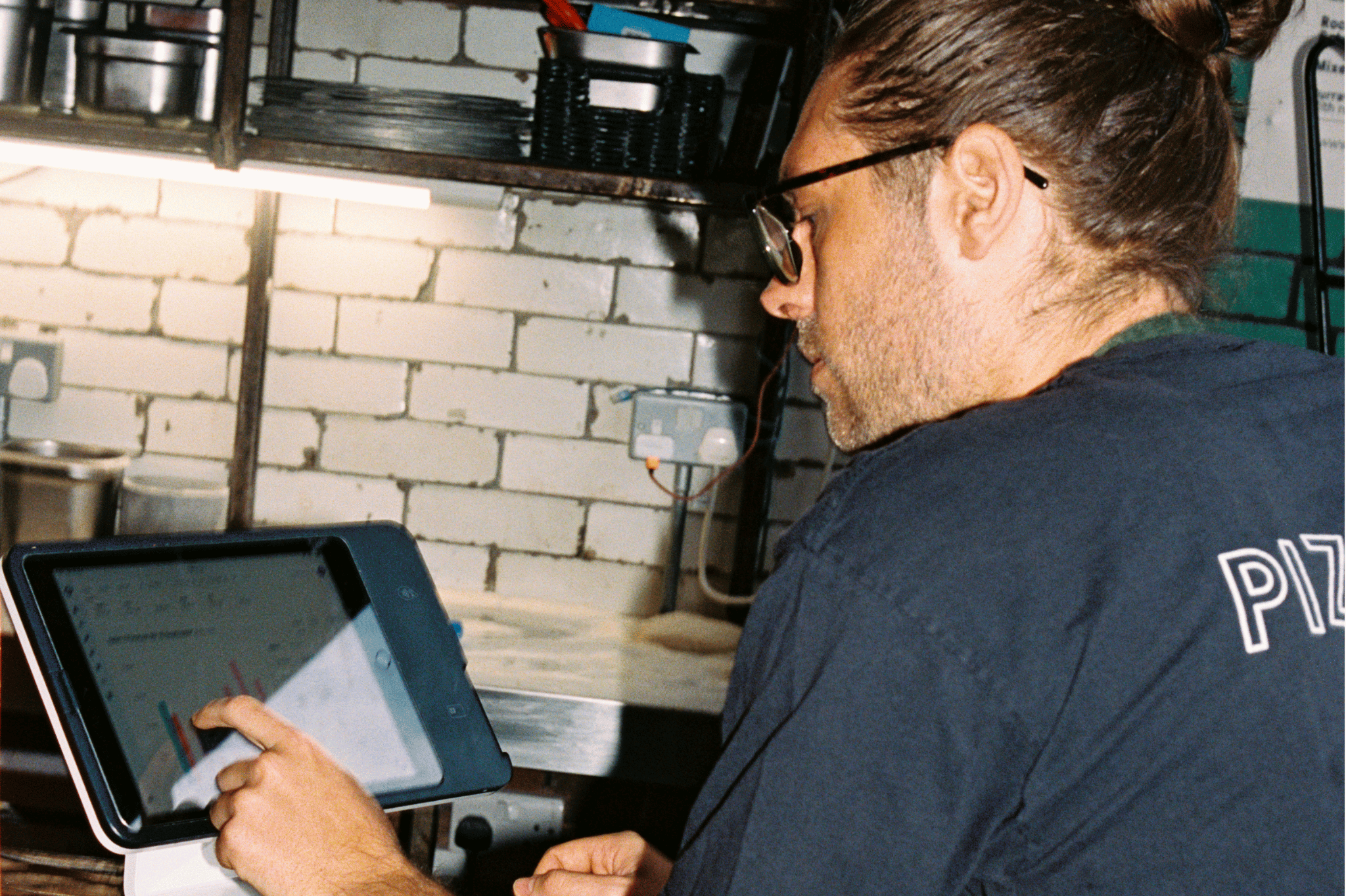 Restaurant operator reviewing real-time sales with Nory