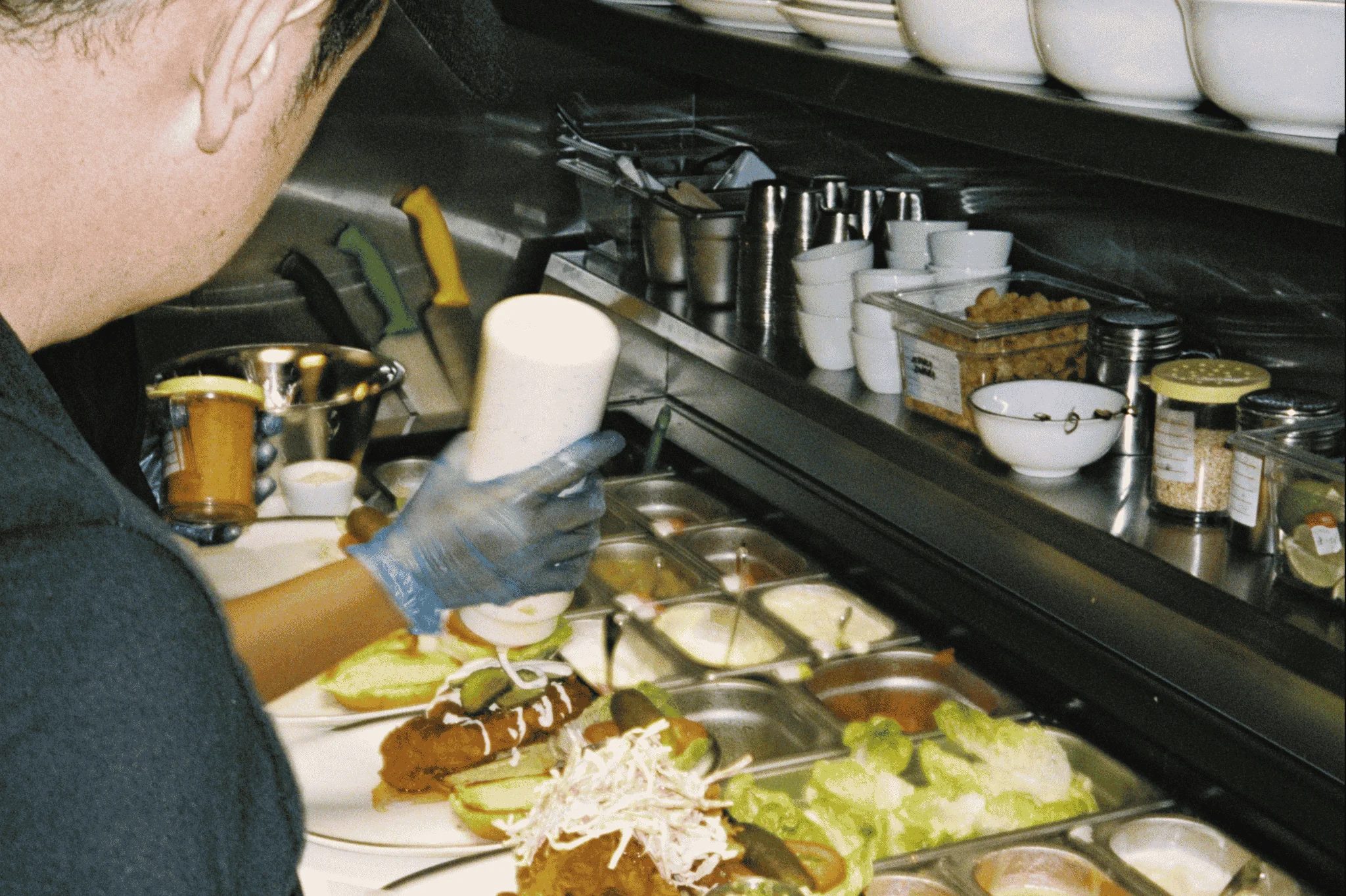 Restaurant employees plating food for customers