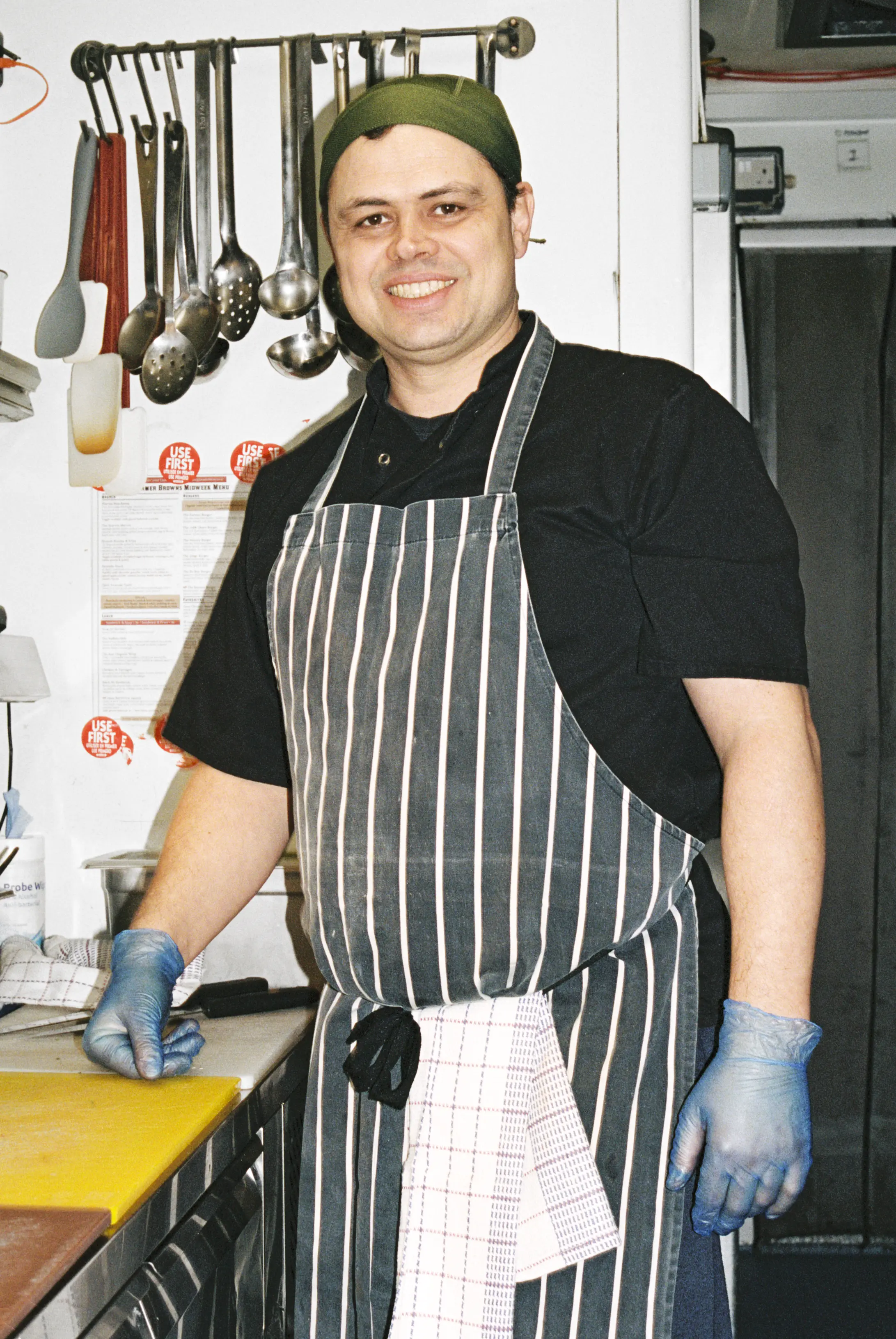 Restaurant employee smiling while in the kitchen