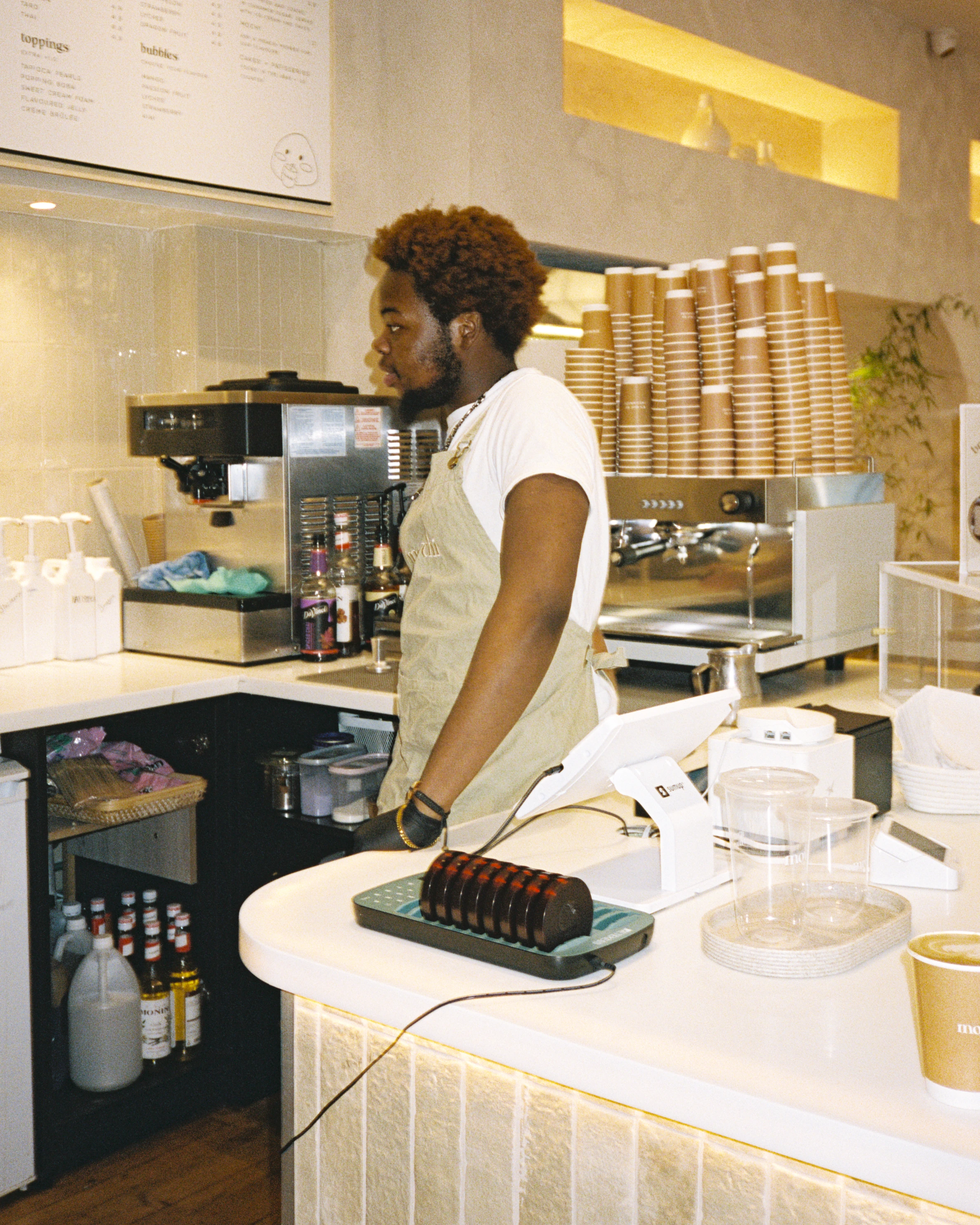Cafe employee working behind the counter
