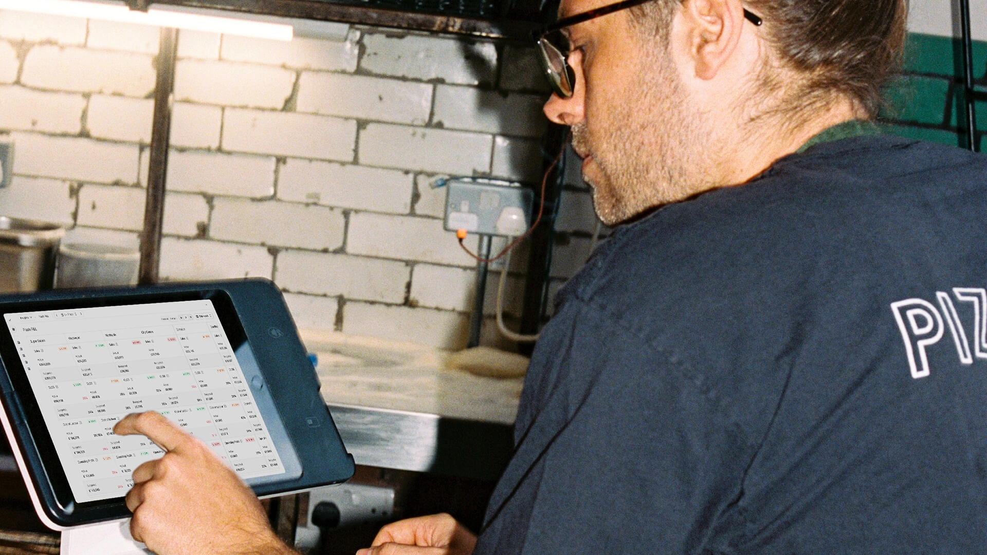 Restaurant employee using Nory to track real-time insights on a tablet