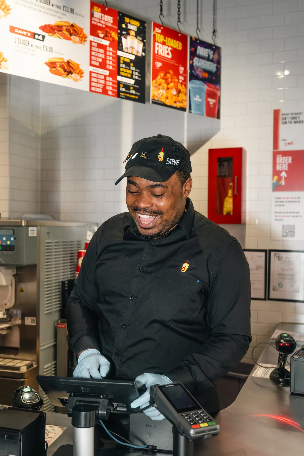Restaurant employee smiling while taking order