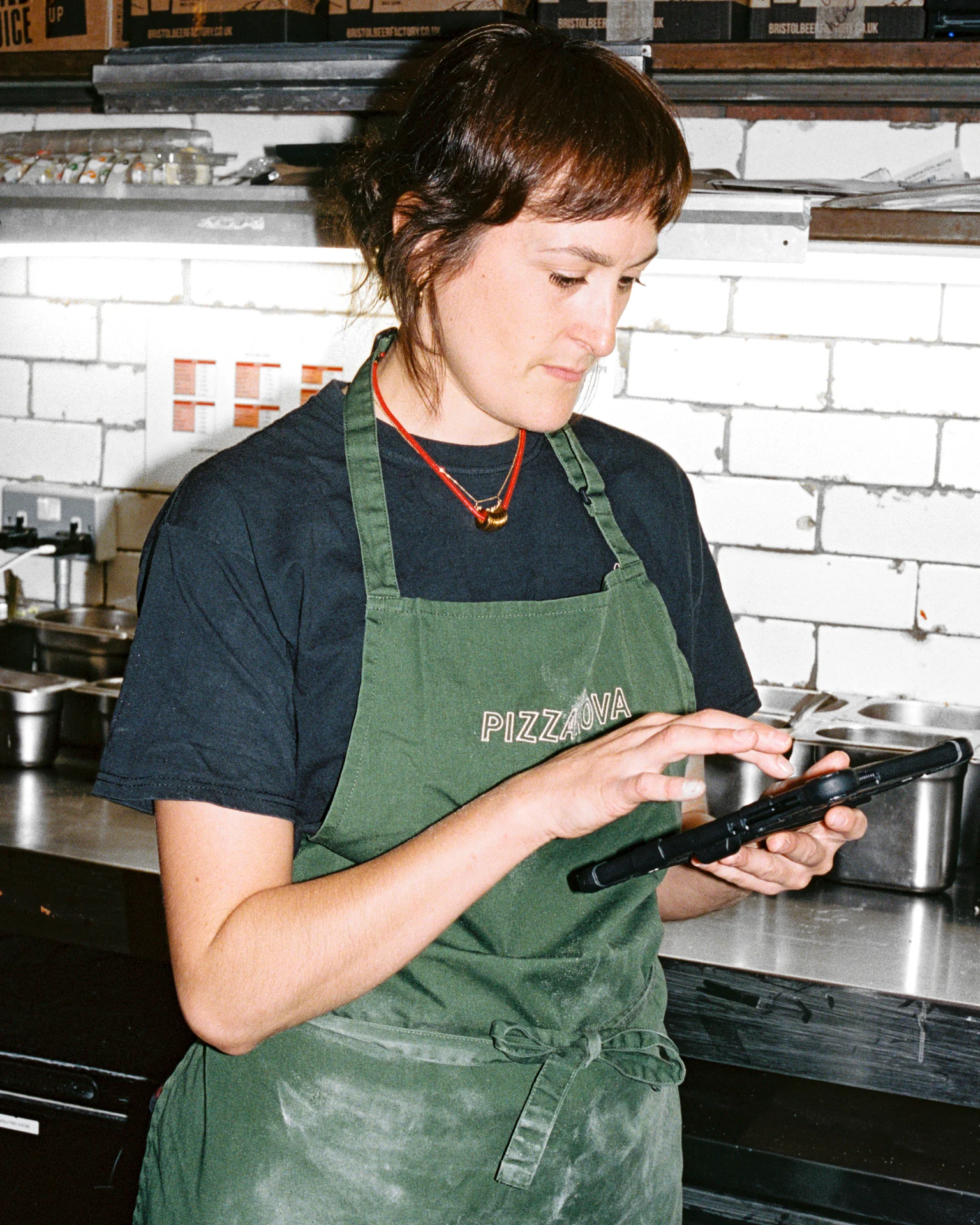 Pizzarova employee using Nory AI on a tablet