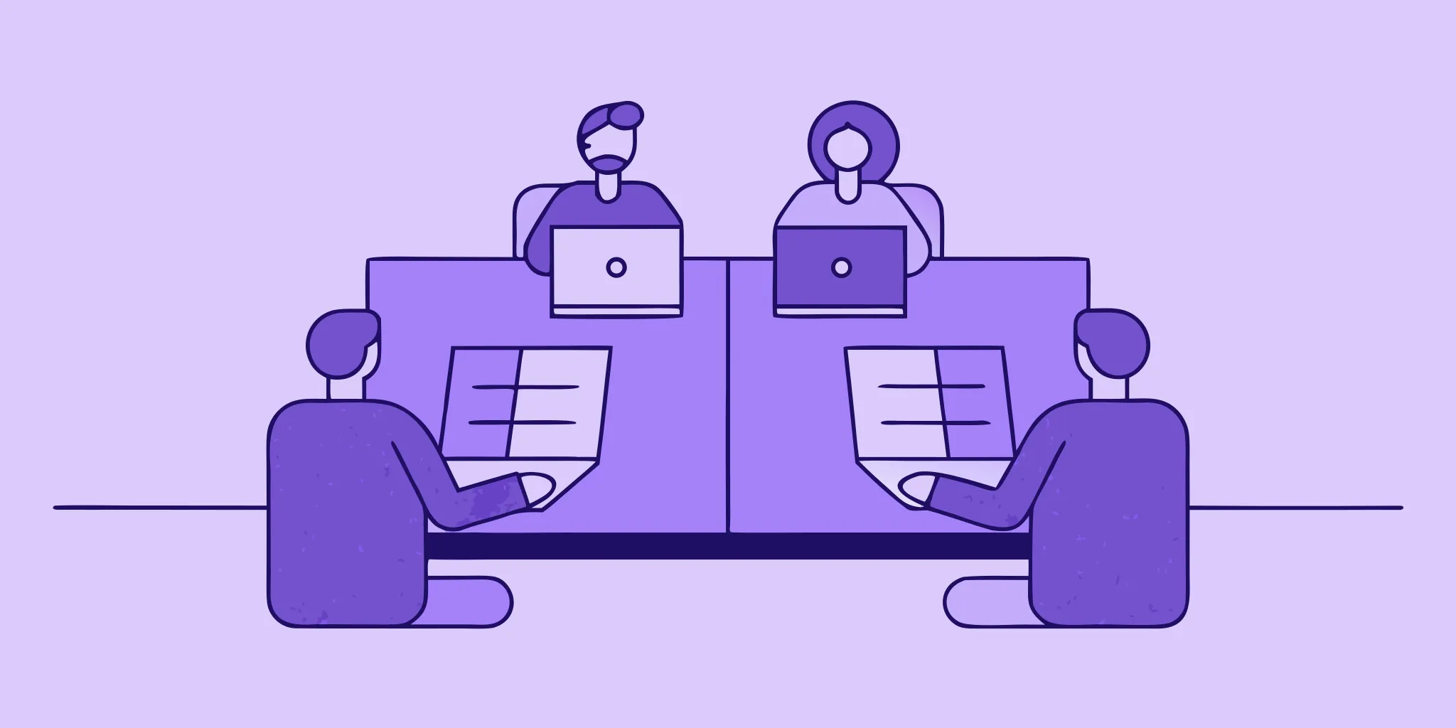 A bid manager and team collaborating on a proposal with laptops and documents.