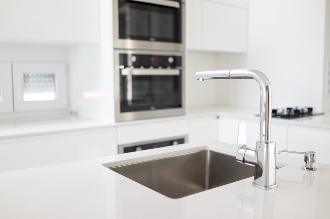 Modern minimalist kitchen with stainless steel sink and built-in oven