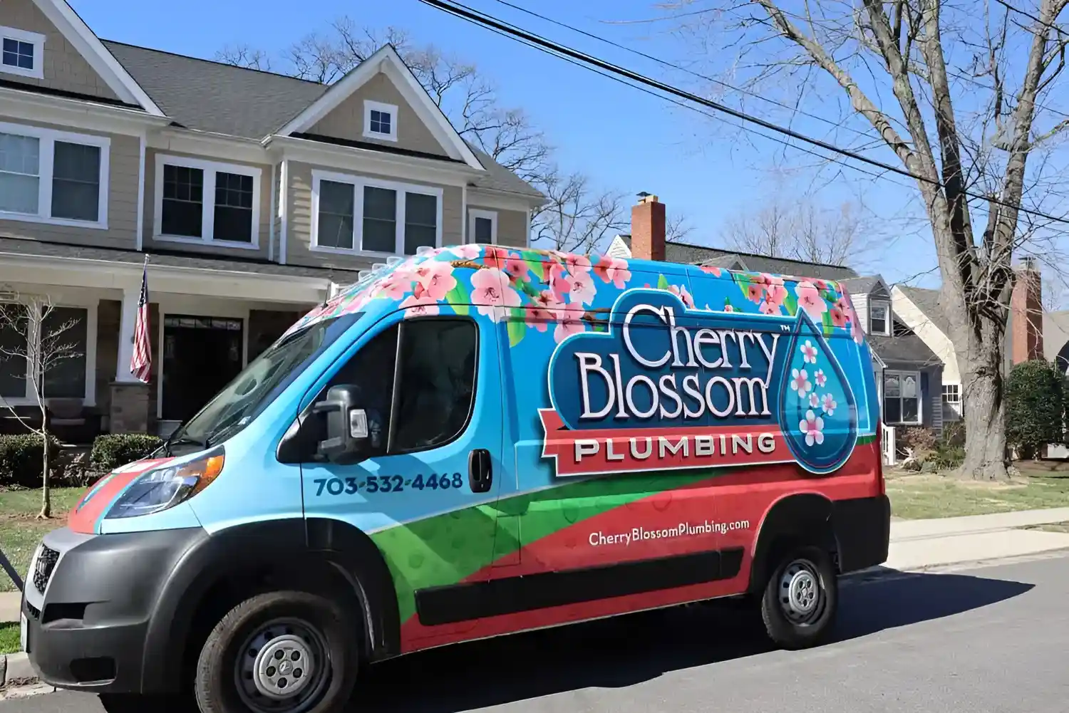 Colorful Cherry Blossom Plumbing van parked on suburban street