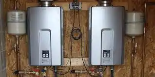 Two tankless water heaters mounted on wooden wall with pipes and connections