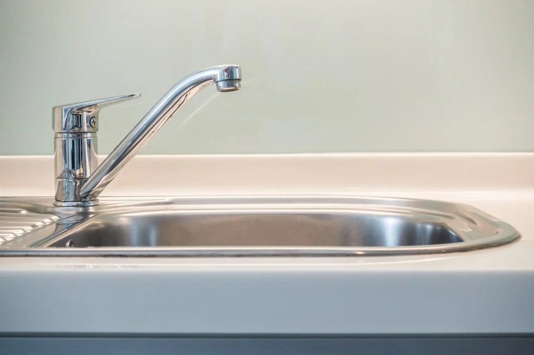 Stainless steel kitchen sink with modern chrome faucet