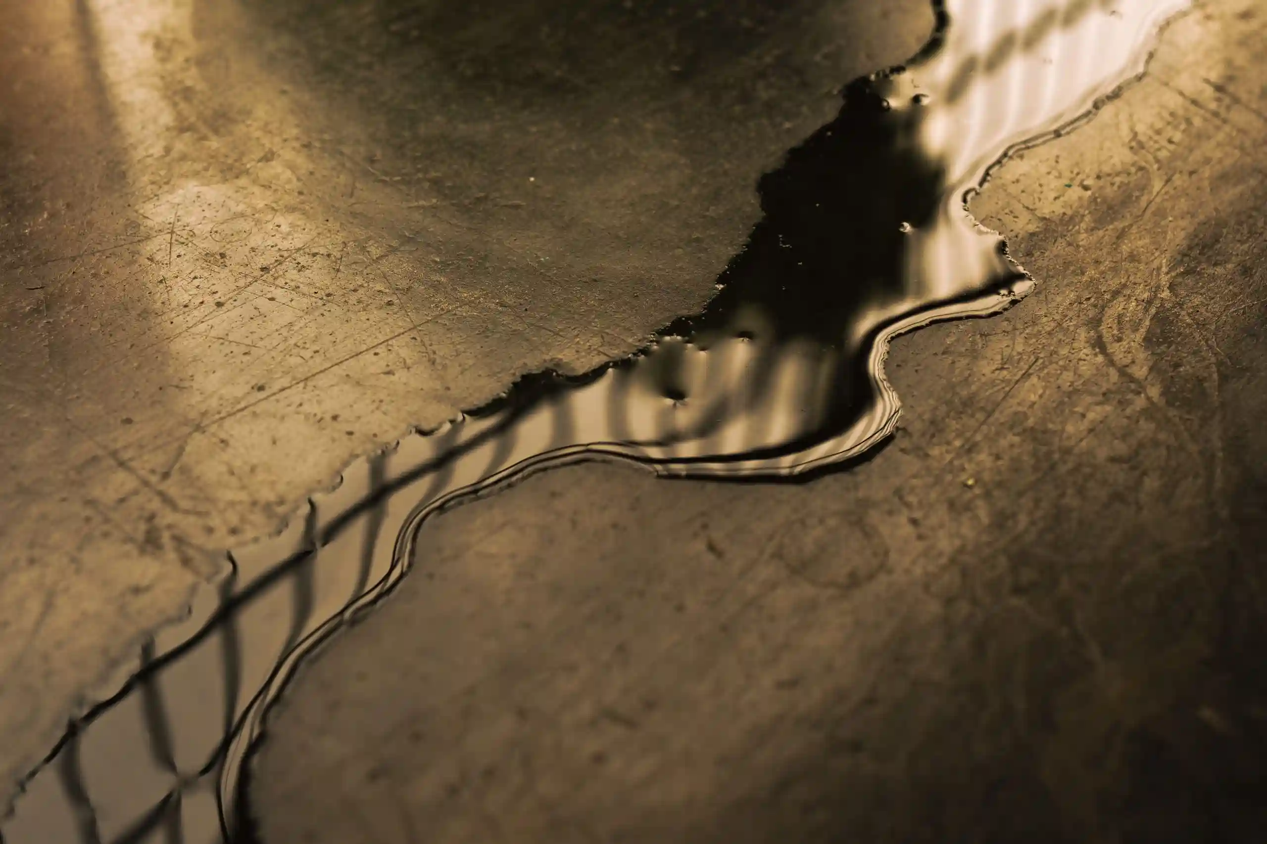 Winding liquid metal stream flowing across textured metallic surface