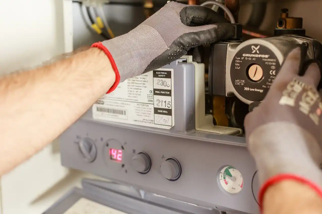 Technician checking settings on a Grundfos pump control panel