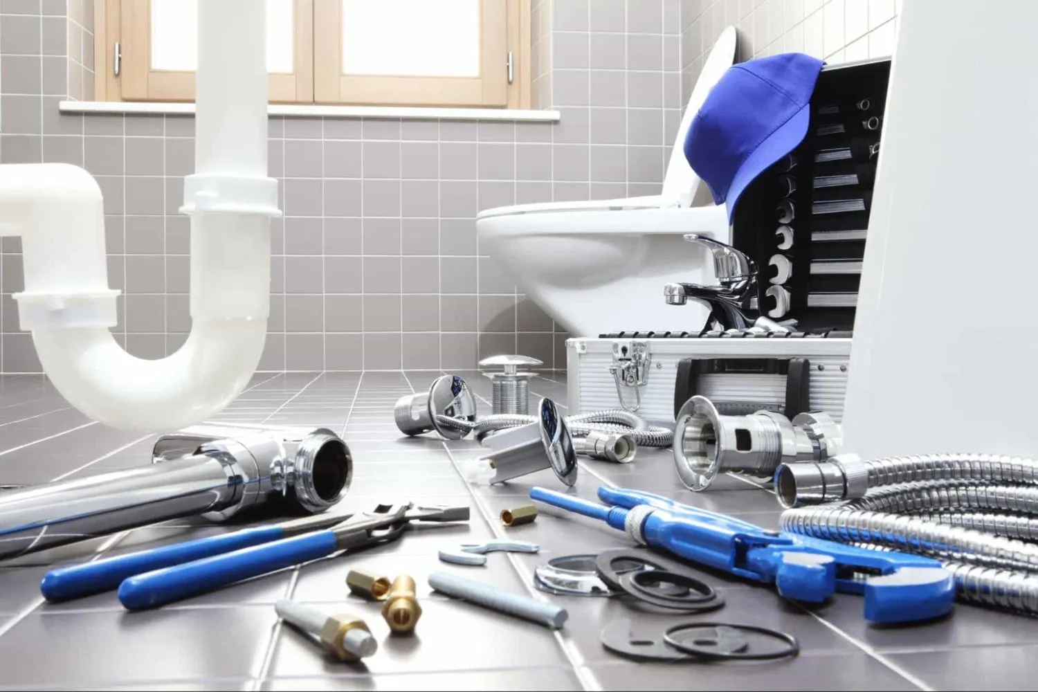 Plumbing tools and pipes arranged for bathroom repair or installation