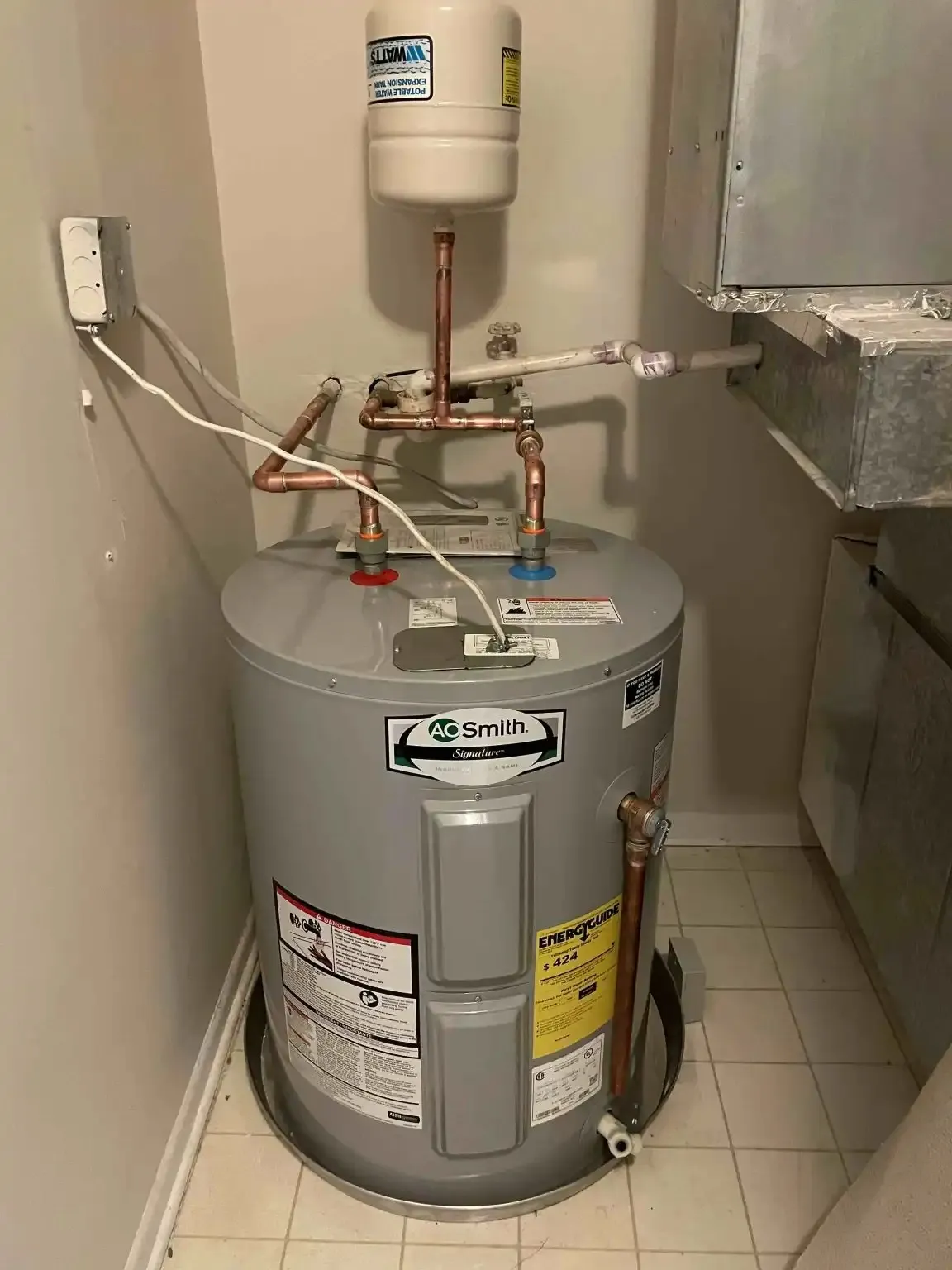 AO Smith water heater with copper pipes installed in utility room