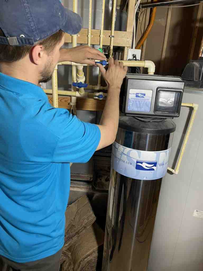 professional plumber installing a water filter system on a cold water line - water filter for tankless water heater professional plumber installing a water filter system on a cold water line - water filter for tankless water heater